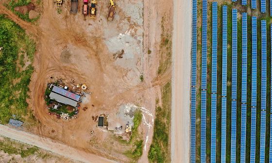 worker inspecting solar panels in vast field renewable energy technology 3 solar systems 3 power generation